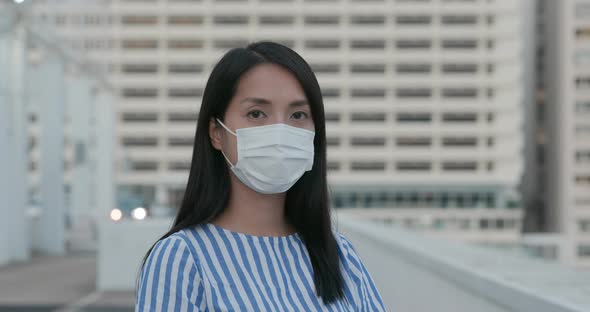 Woman wear face mask and look at camera 