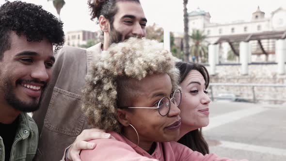 Young Friends Making Funny Faces While Taking Selfies on Mobile Phone alt