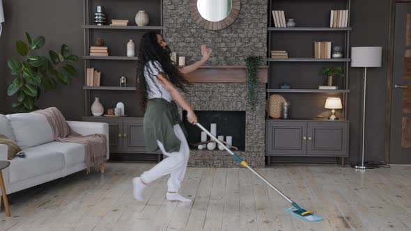Active Joyful Young Woman Housewife Washes Floor with Mop in Living Room Cleans at Home Happy alt