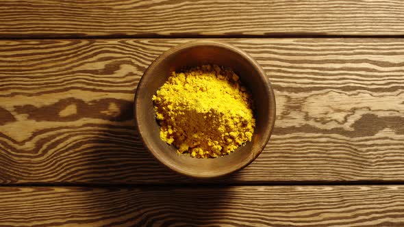 Portions Of Curcuma Appear In A Wooden Cup 
