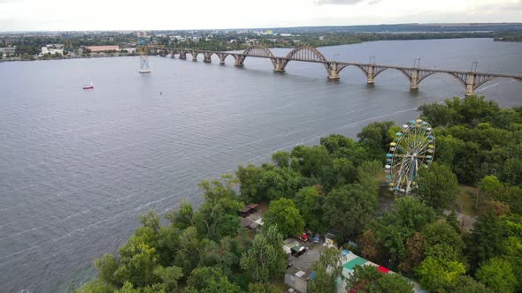 Europe's Unique Arched Railway Bridge Over the Dnieper River with a Lively Embankment and Yacht Club