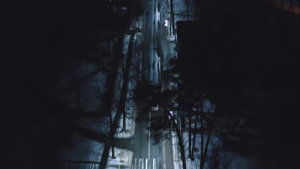 Aerial Top Down View of Illuminated City Road at Night with Car