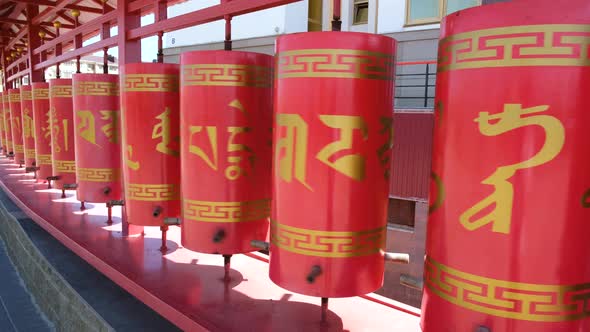 Close up red prayer drums of purification of karma in a  buddhist monastery alt