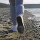 Closeup of the Legs of a Runner Who Runs Along the Seashore - VideoHive Item for Sale