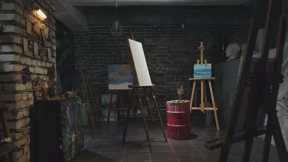 An Art Studio with a Blank Canvas in the Middle alt