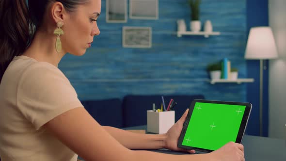 Woman Working at Office Desk Using Mock Up Green Screen Tablet Computer alt