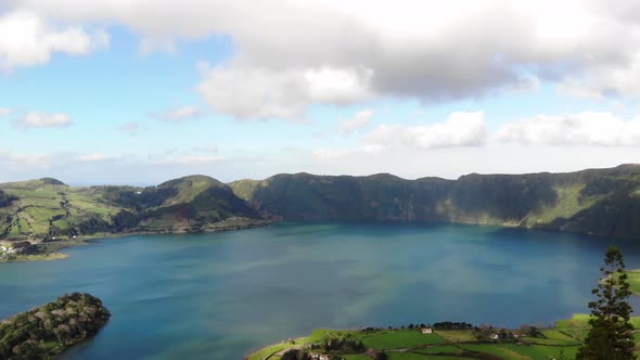 Panoramic view of Lagoa Azul (Blue Lake) in Sete cidades, Ponta Delgada, Azores - Fly forward aerial alt
