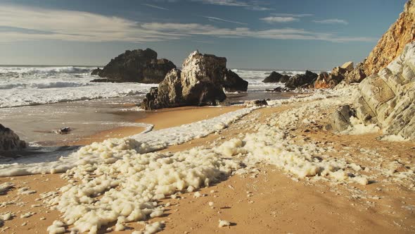Sea Foam (aka Beach Foam, Ocean Foam or Spume) on a Sandy Beach on the Atlantic Coast of Portugal at alt