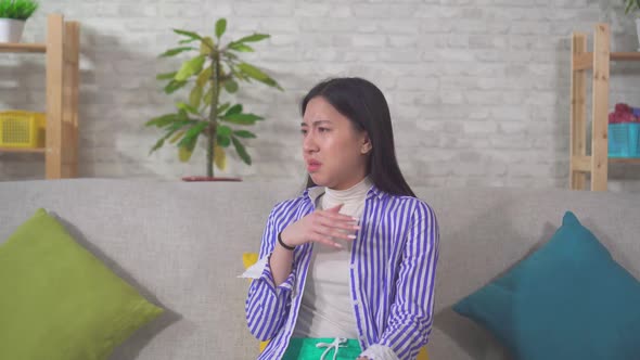 Portrait Asian Female Feels Bad Smell Home Sitting Couch alt