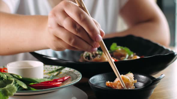 Woman Eating Traditional Asian Soba Stir-fry Noodles with Shrimp
