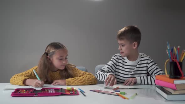 Slow Motion of Two Caucasian Schoolchildren Tossing Up Notebooks and Smiling alt