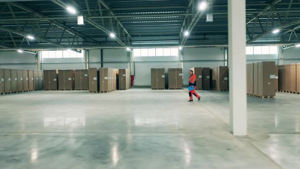 Professional Storage Worker Is Walking Along the Refrigeration Factory Unit alt