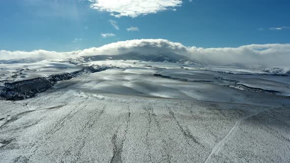 Time lapse drone shot of forward tracking plain, with passing clouds alt