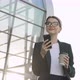 Extremely beautiful Businesswoman using her Phone, drinking Coffee take away. - VideoHive Item for Sale