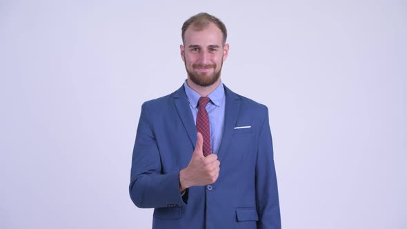 Happy Bearded Businessman Giving Thumbs Up