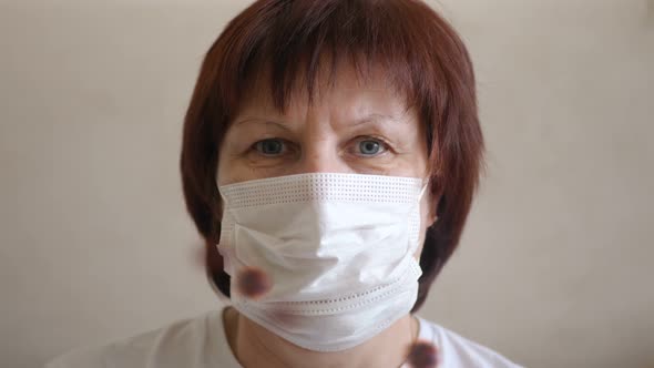 Woman Putting on Surgical Mask for Corona Virus Prevention.