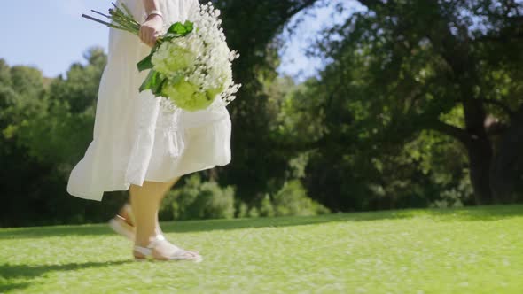 Romantic Woman Walking in Green Park at Beautiful Forest Bokeh Background RED alt