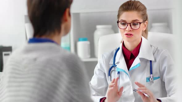 Attractive Woman Doctor in Glasses and Uniform Consultation Mature Female Patient Discussing Disease alt