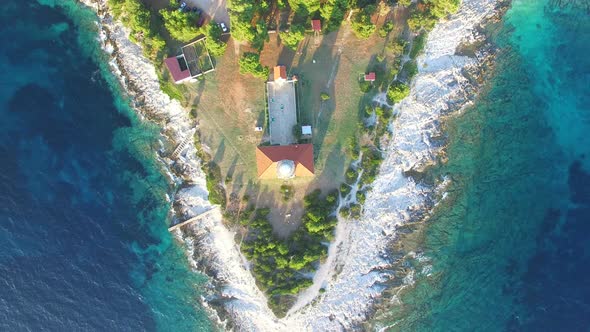Flying over lighthouse, Croatia with a red tiled roof alt
