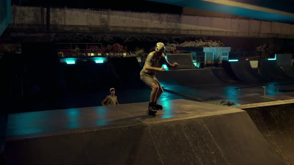 Sportive People Doing Exercise Together on Roller Skates and Skateboard in Ramp alt