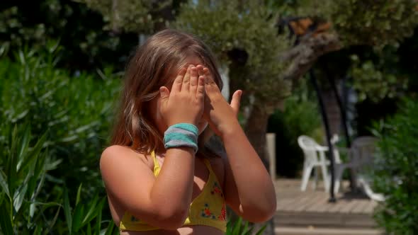 Mother's Hand is Smearing a Protective Cream on the Face of the Little Cute Girl alt