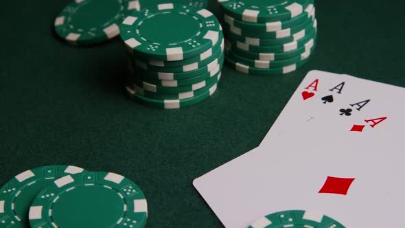 Rotating shot of poker cards and poker chips on a green felt surface - POKER 005 alt