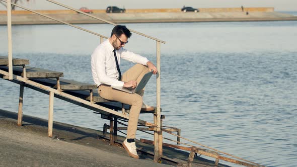Businessman And Laptop On Steps. Freelancer Internet Online Meeting Webinar.  Distance Mobile Job. alt