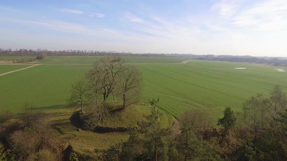 Camera Track Over The Treetops Toward The Grave Ends In Mid Shot Of The Entrance