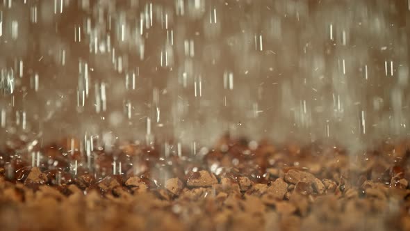 Super Slow Motion Macro Shot of Water Droplets Falling on Instant Coffee at 1000 Fps. alt