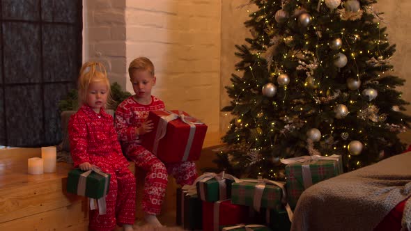 Cute Children with Christmas Presents at Home