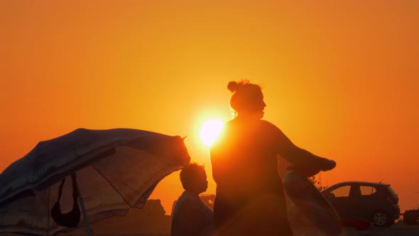 Family at the beach after bathing View at sunset alt