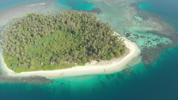 Aerial: flying over coral reef tropical caribbean sea, turquoise blue water alt