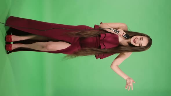 Portrait of Beautiful Young Woman Sings a Fast Funny Song and Dances to the Beat of the Music alt