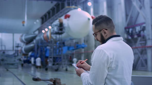 Industry Concept Man Engineer in Modern Hangar of Space and Aviation Transport alt