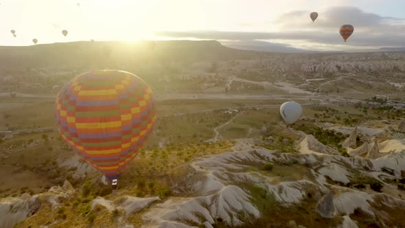 Aerial Hot Air Balloons Flying Over Hoodoos Fairy Chimneys in Cappadocia Turkey at Sunrise Morning alt