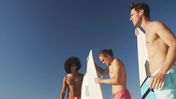 Men looking at the view with surfboards alt