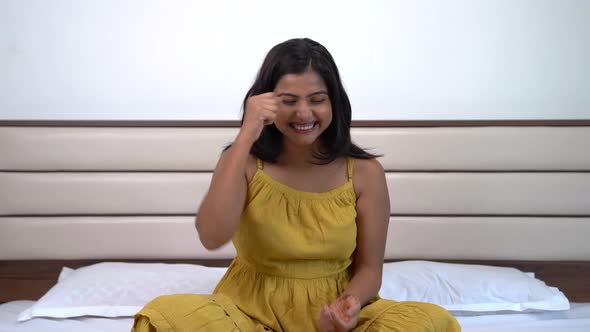 Attractive Indian young adult got and idea and celebrating with a smile alt