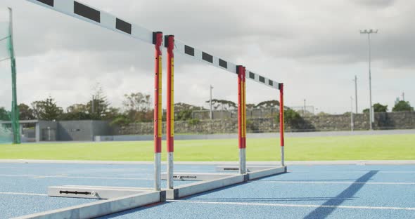 Side view of african american athlete doing hurdling alt