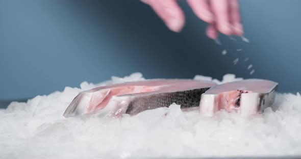 Fishmonger's Hand Puts Sliced Salmon On Top Of Ice - slow motion alt
