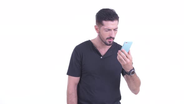 Profile View of Lost Young Bearded Man Using Phone As Map alt