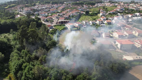Aerial view of firefighters extinguishing fire in Forest area. alt
