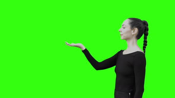Young Woman Walking and Stoping to Communicate With a Virtual Entity Green Screen. alt