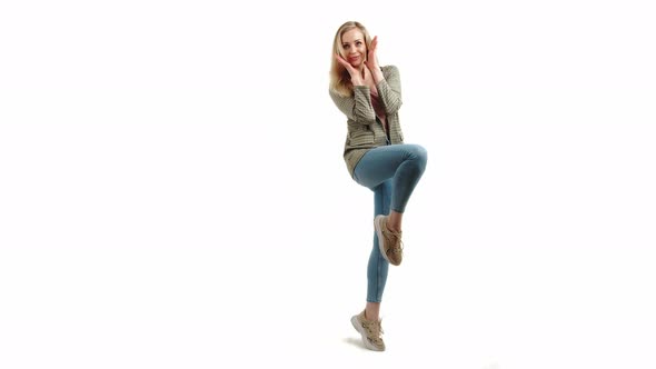 Surprised Beautiful European Blonde Girl with One Foot Up Holding Hands Outstretched and Smiling alt