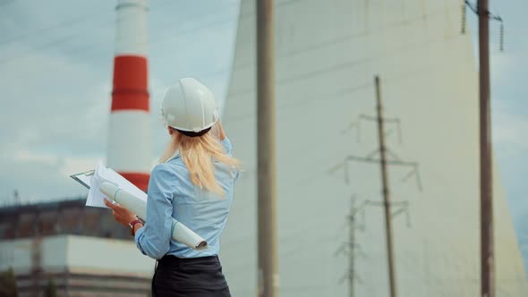 Technician On High Voltage Wire Line. Worker On Energy Transmission Tower. Distribution Station. alt