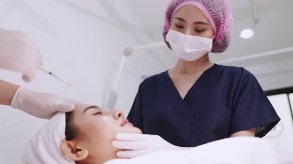 Beauty clinic concept. Young woman getting professional facial procedure. alt