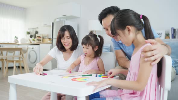 Happy family activity, Little girl children learn how to draw art picture in living room at home. alt