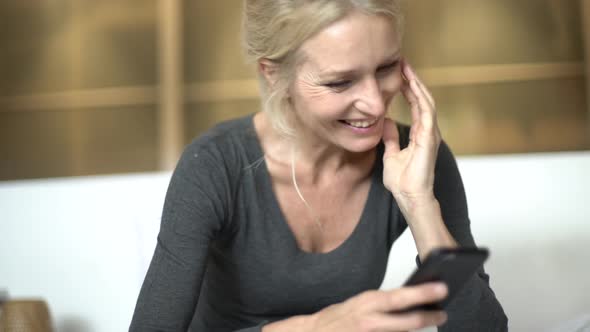 Mature woman texting on her smart phone