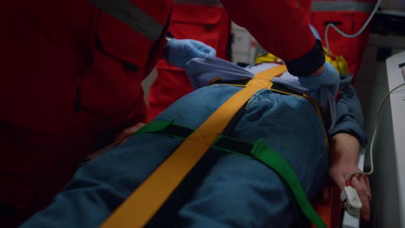 Professional Paramedics Performing First Aid Procedure in Emergency Car alt