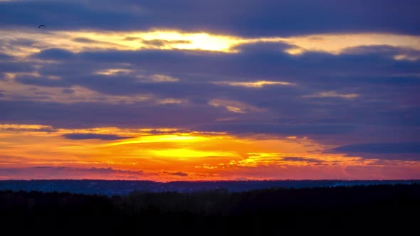 Dramatic Sunset in the Sky Through Orange Layered Cumulus Clouds Timelapse alt