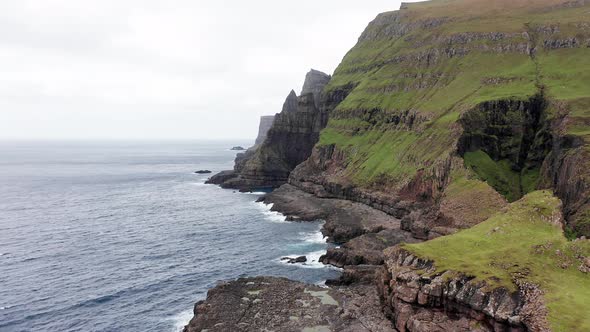 Aerial Back View of Huge Cliffs in Faroe Islands Green Rocky Mountainpowerful Ocean Wavesin a Cloudy alt